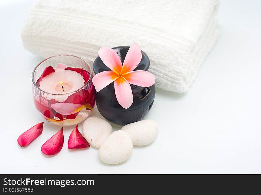 Plumeria flower, white stone, towel and candles for the traditional treatment. Plumeria flower, white stone, towel and candles for the traditional treatment