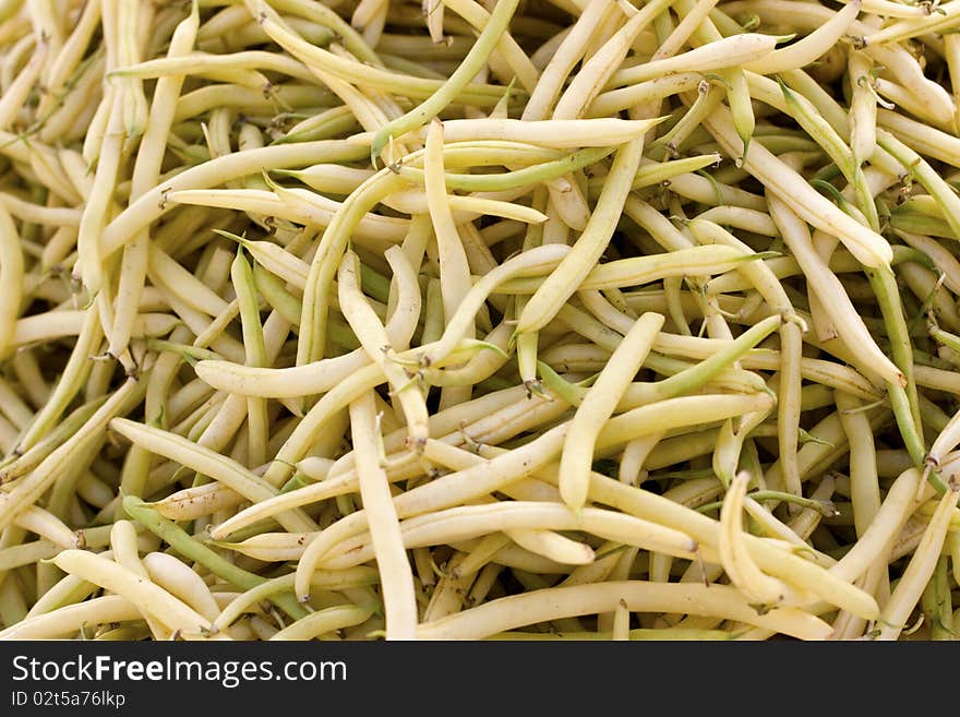 A hip of pale yellow beans on the farmer's market