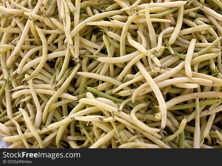 A hip of pale yellow beans on the farmer's market