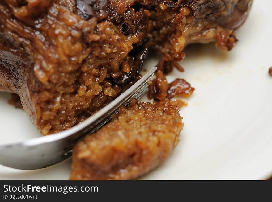 Macro shot of fork on delicious meat dumpling. For food and beverage, customs and traditions, and local and creative cuisine concepts. Macro shot of fork on delicious meat dumpling. For food and beverage, customs and traditions, and local and creative cuisine concepts.