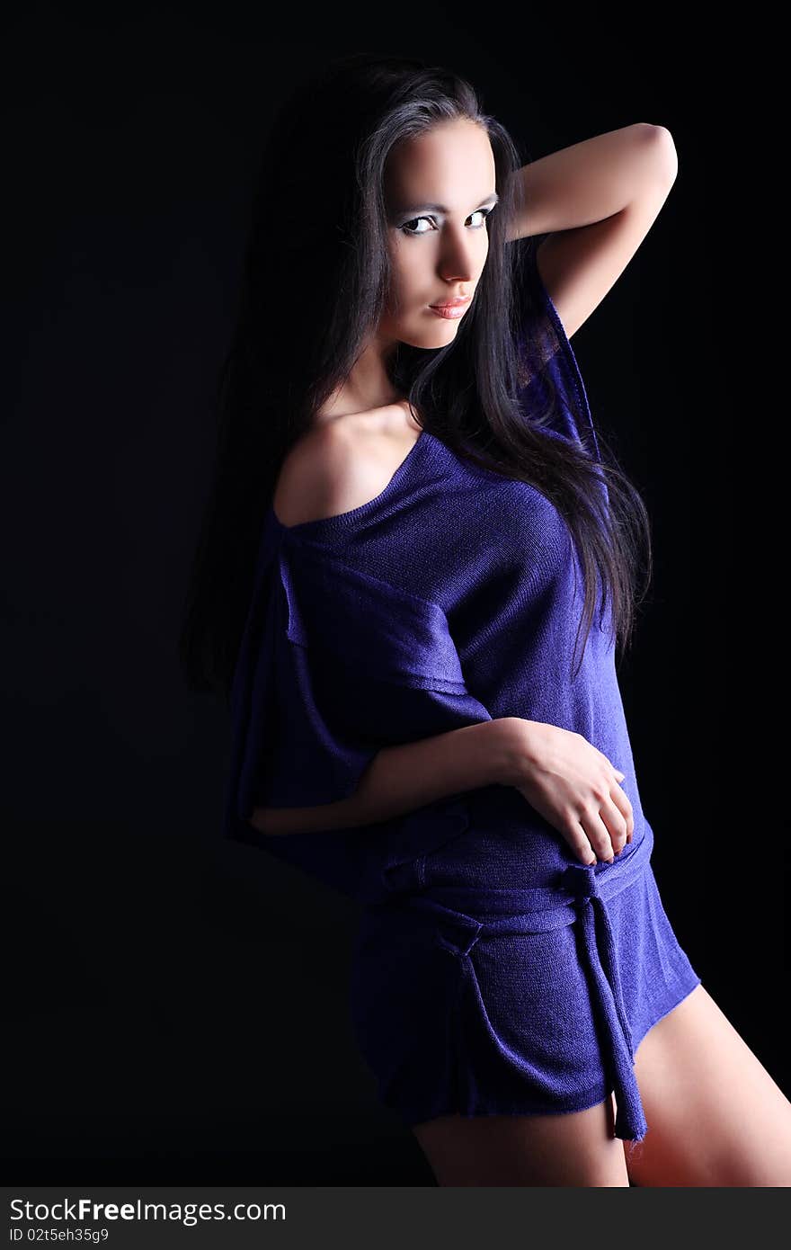 Fashion photo, a model is  posing over black background. Fashion photo, a model is  posing over black background