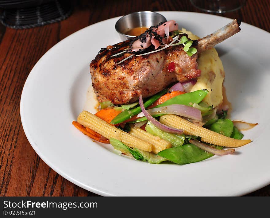 Pork Chop served on a Plate with Vegetables