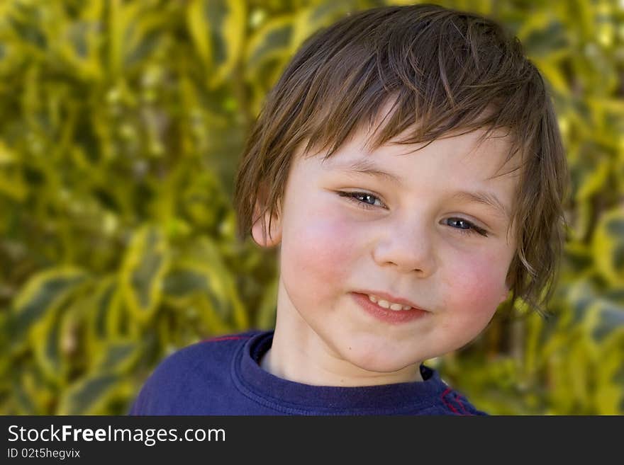 Happy five year old boy posing outdoors. Happy five year old boy posing outdoors