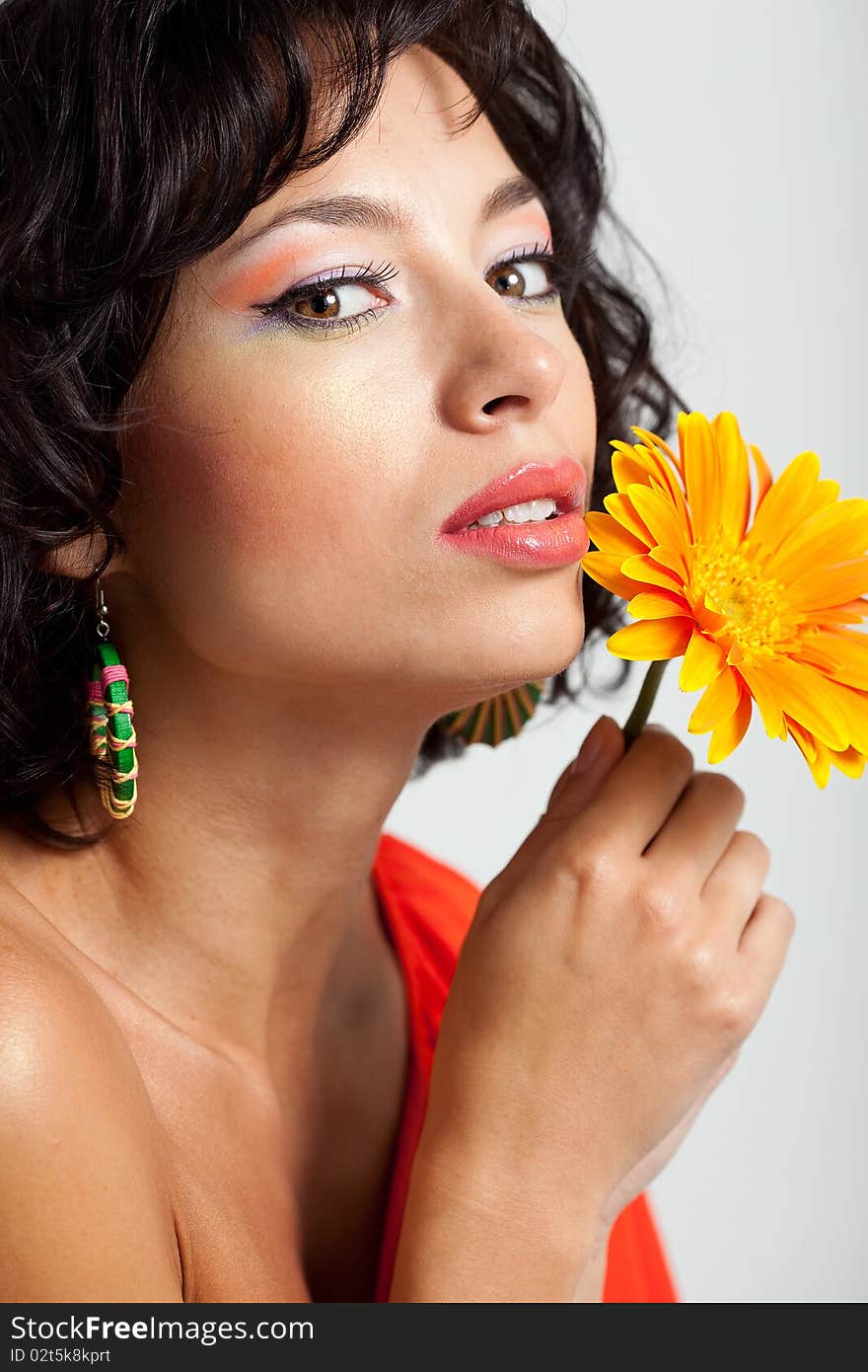 Beautiful woman with flower at studio