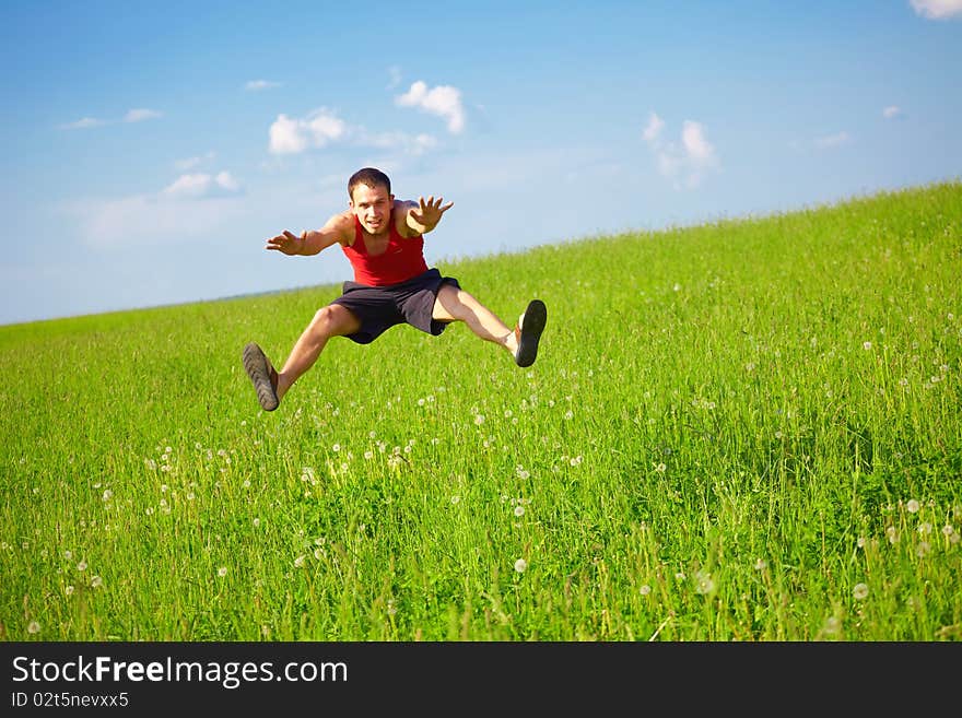 Young man jumps into the field