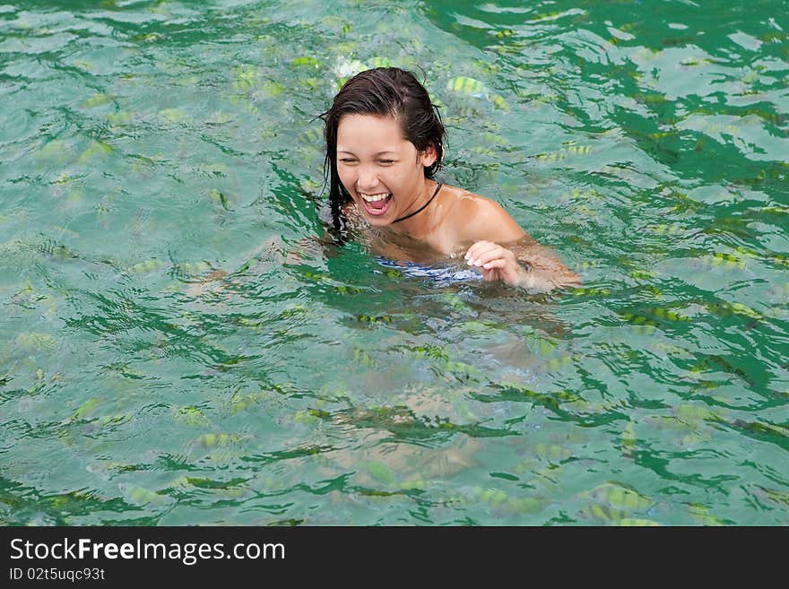 Girl swims with tropical fish, adventure in the sea