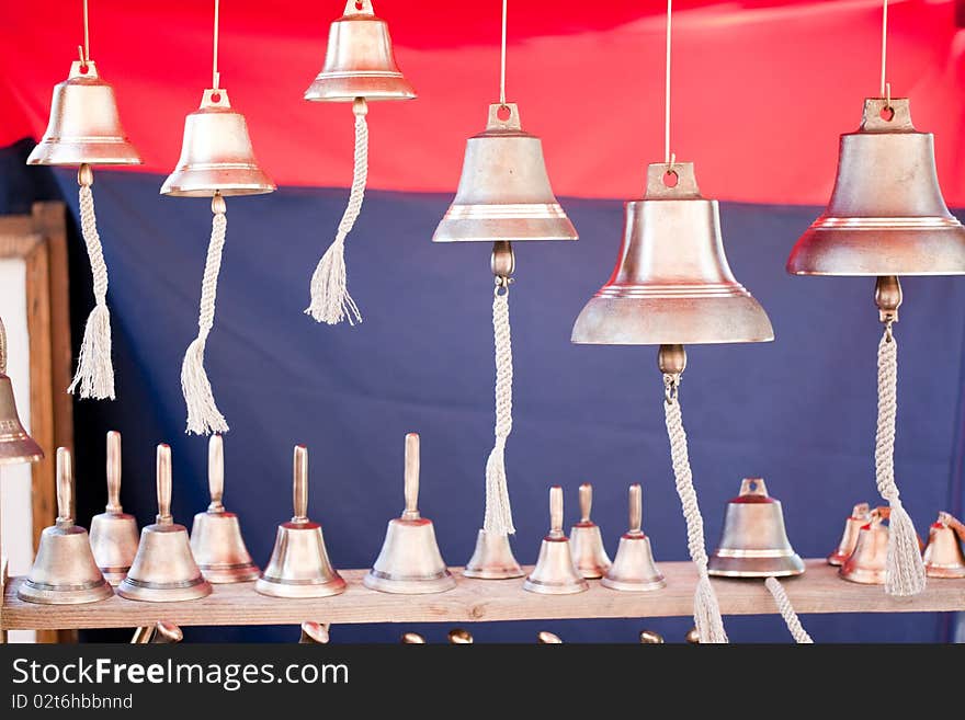 Closeup photo of brass bells of different sizes.