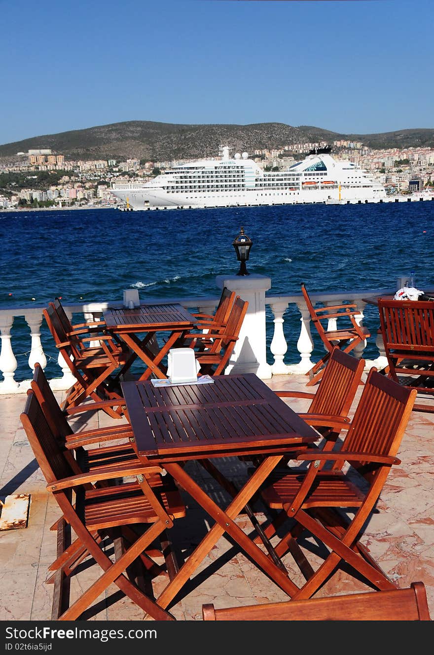 Exotic scenery with a terrace in Kusadasi Turkey with a ship in the background. Exotic scenery with a terrace in Kusadasi Turkey with a ship in the background