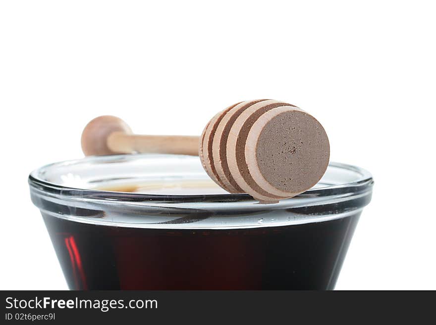 Honey in glasswares with wooden honey dipper.