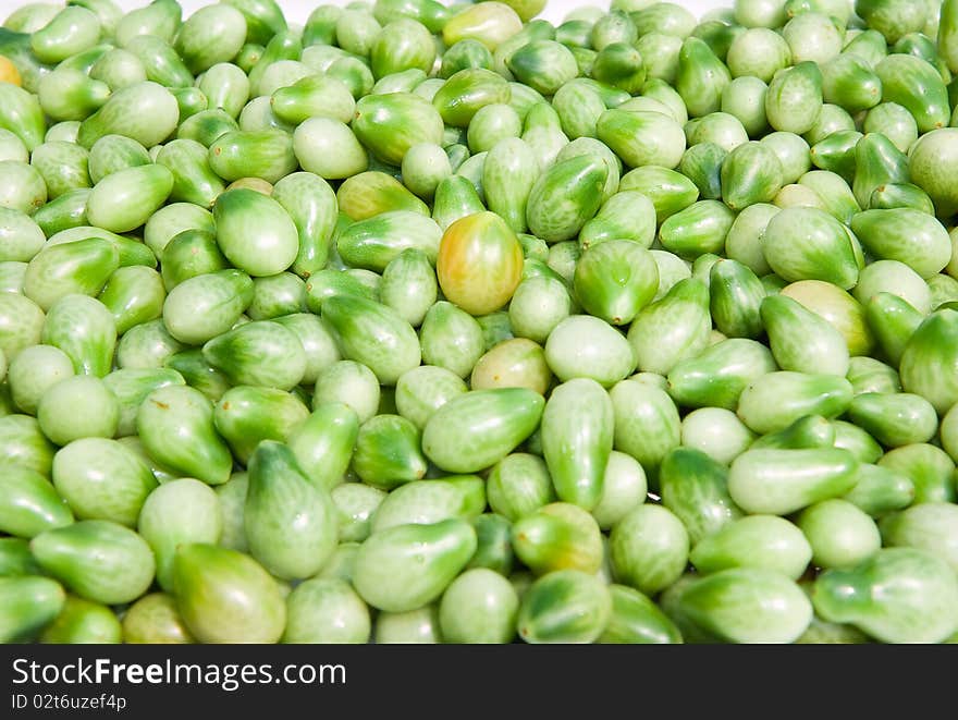 A background of fresh vine green tomatoes for sale at a market