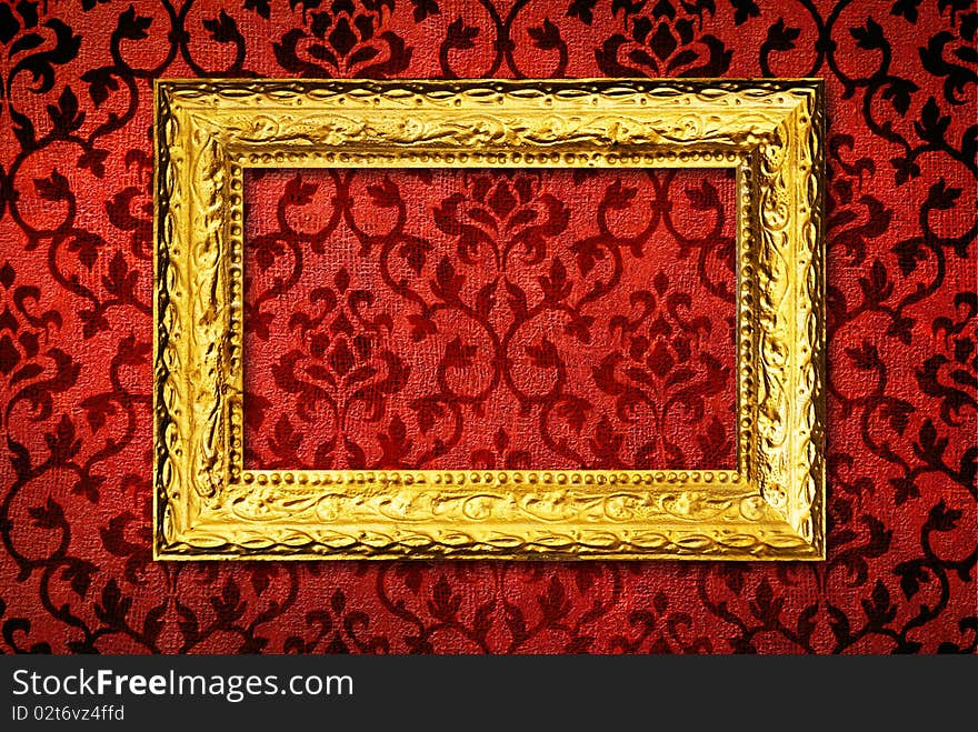 Gold frame on a vintage red wall background