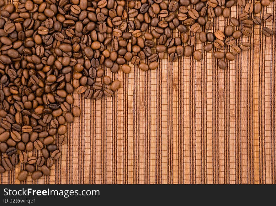 Coffee beans on the wooden background