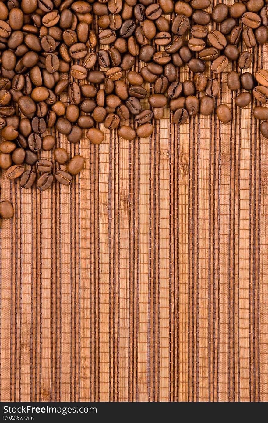 Coffee beans on the wooden background