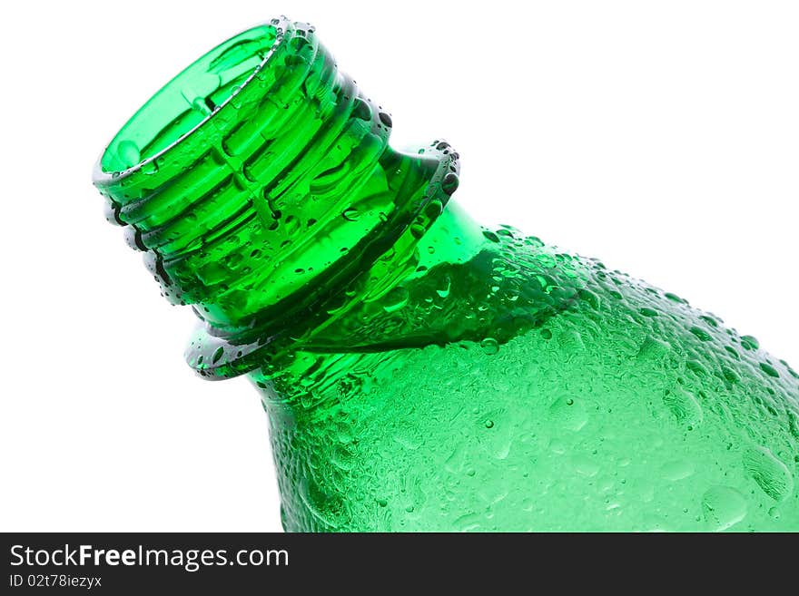 Plastic bottle with water drops on white background