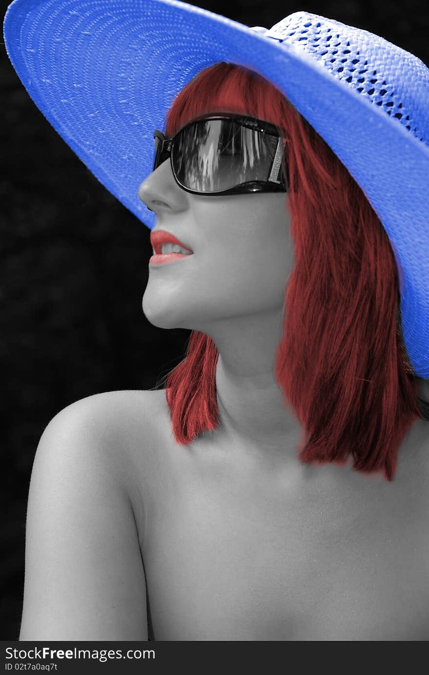 Black and white tinted image of beautiful woman in blue hat. Black and white tinted image of beautiful woman in blue hat