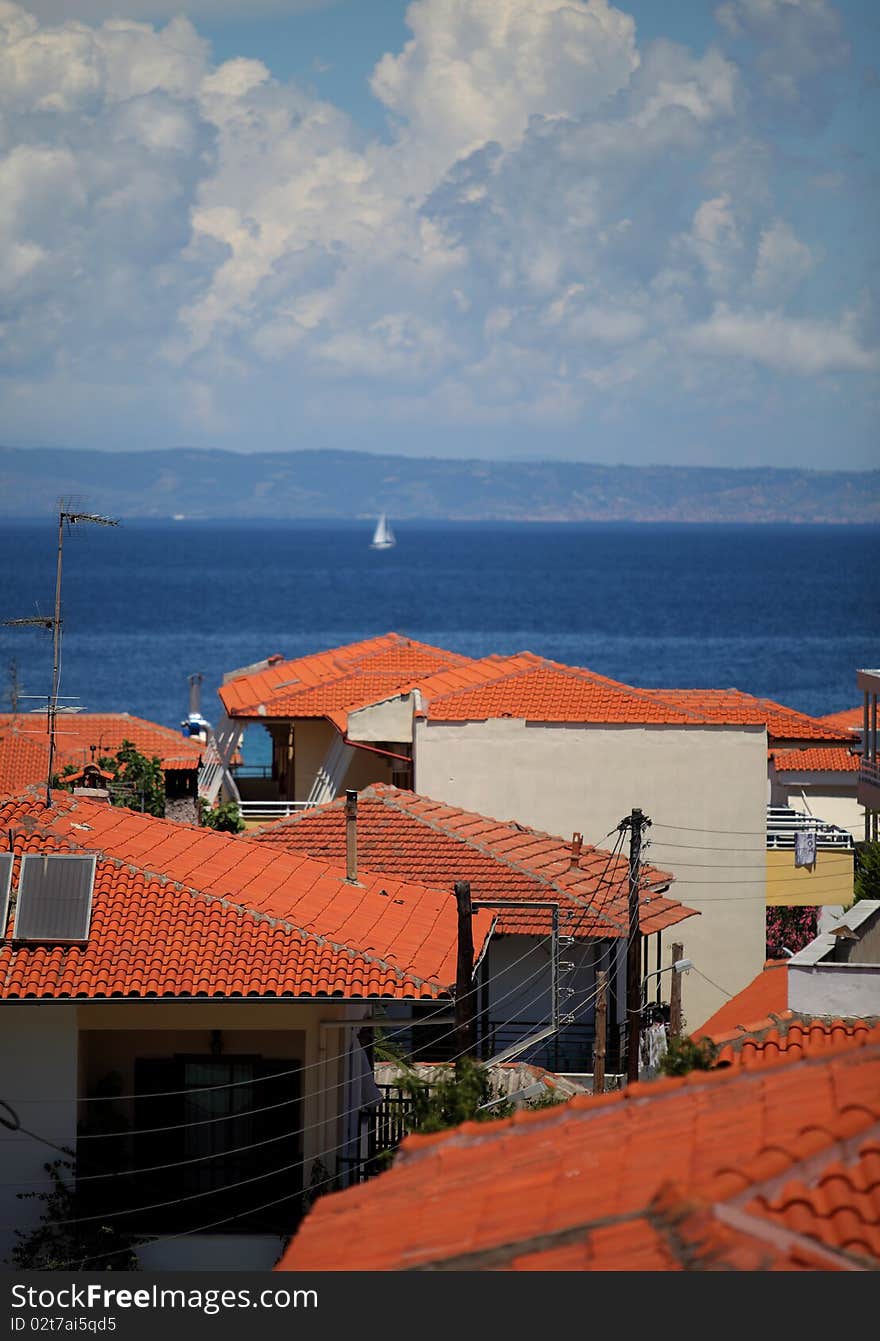 View over red rooftops and the sea at polychrono, greece. View over red rooftops and the sea at polychrono, greece