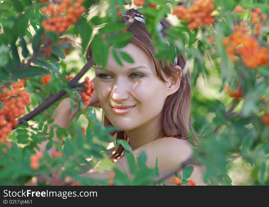 Beautiful girl in the forest with mountain ash