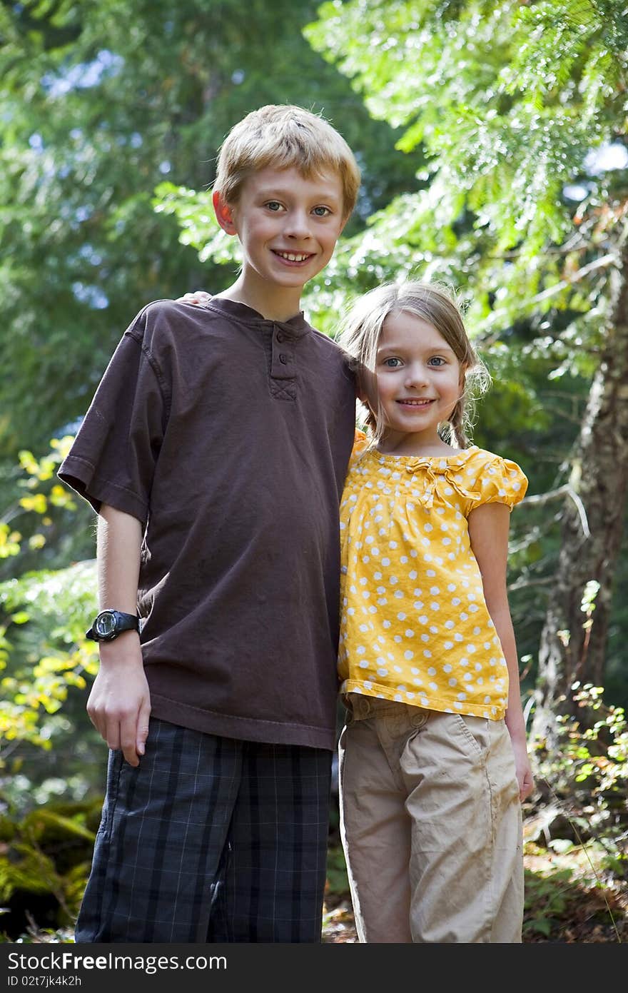 Brother and sister standing outside