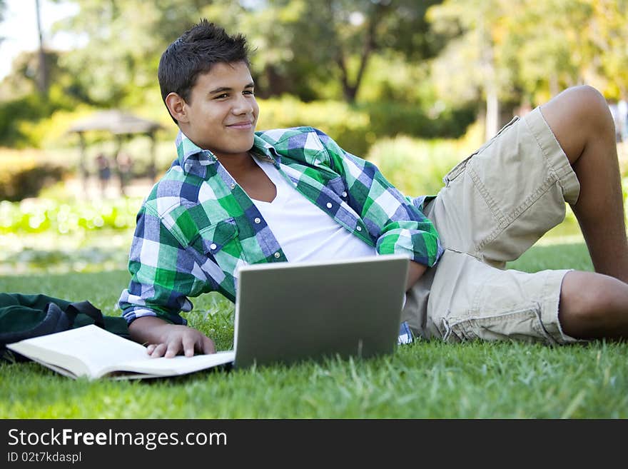 Student with backpack studying outside. Student with backpack studying outside