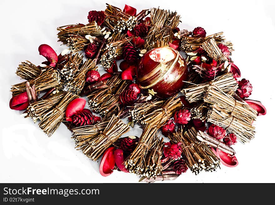 Christmas decorations and candle lit isolated on white