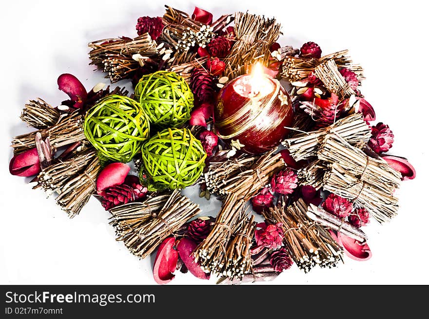 Various christmas decorations with candle lit isolated on white