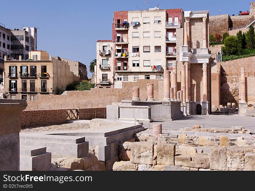 Roman ruins in front of modern housing in Cartagena, Spain. Converted from RAW. Roman ruins in front of modern housing in Cartagena, Spain. Converted from RAW