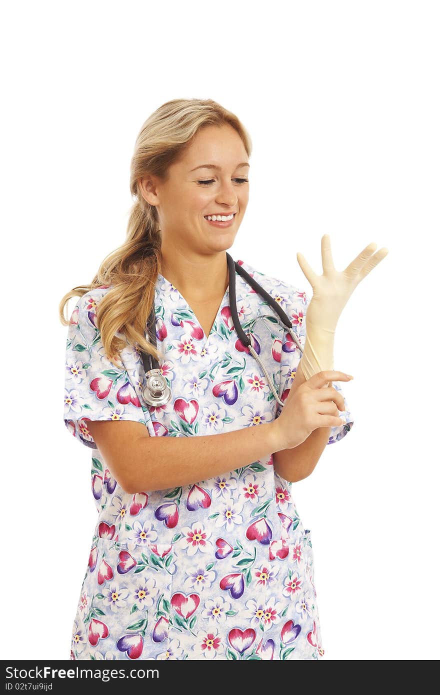 Portrait of young nurse with stethoscope putting on rubber glove