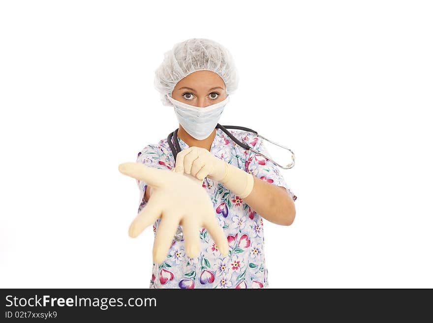 Portrait of young nurse putting on rubber gloves