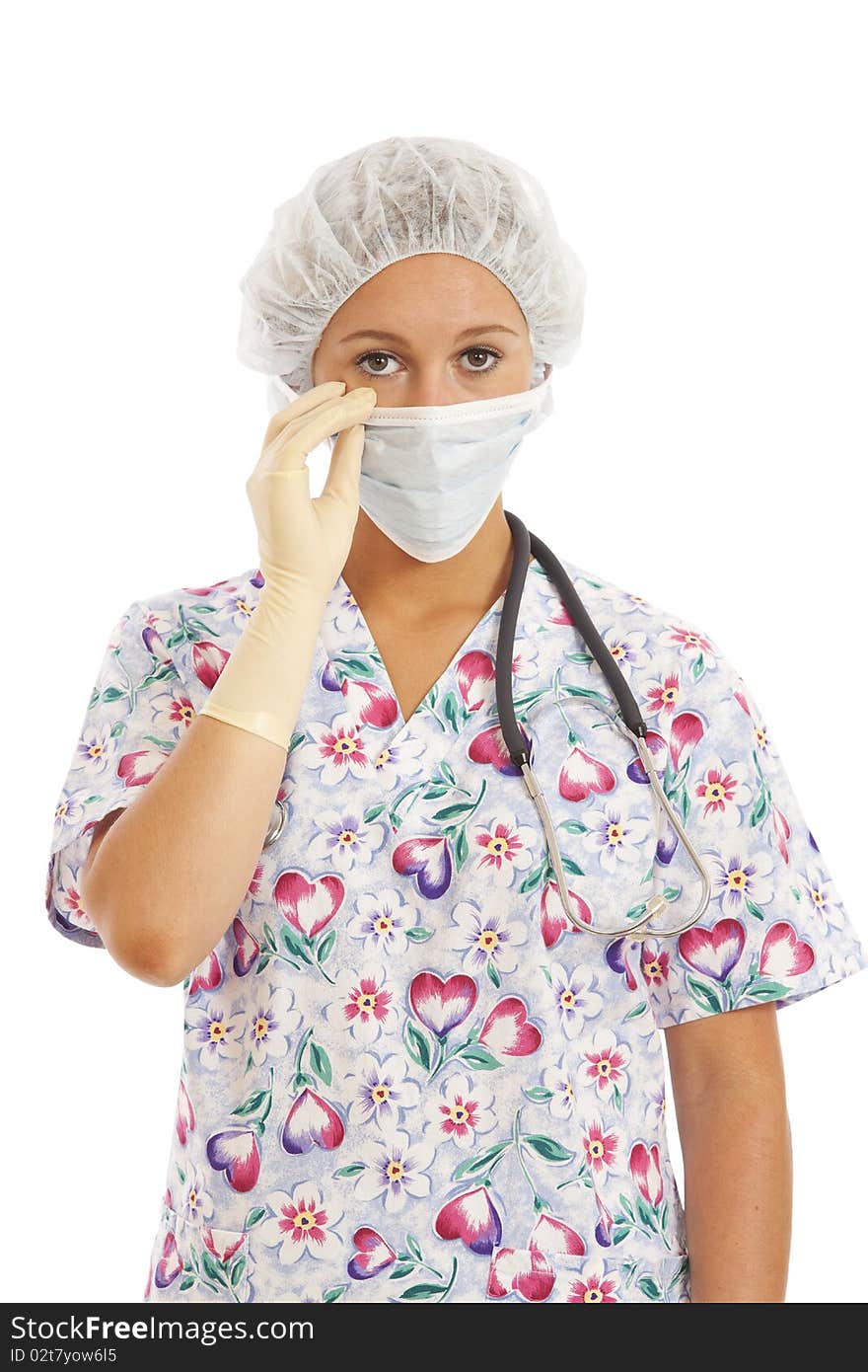 Portrait of young woman nurse in scrubs pulling on mask. Portrait of young woman nurse in scrubs pulling on mask