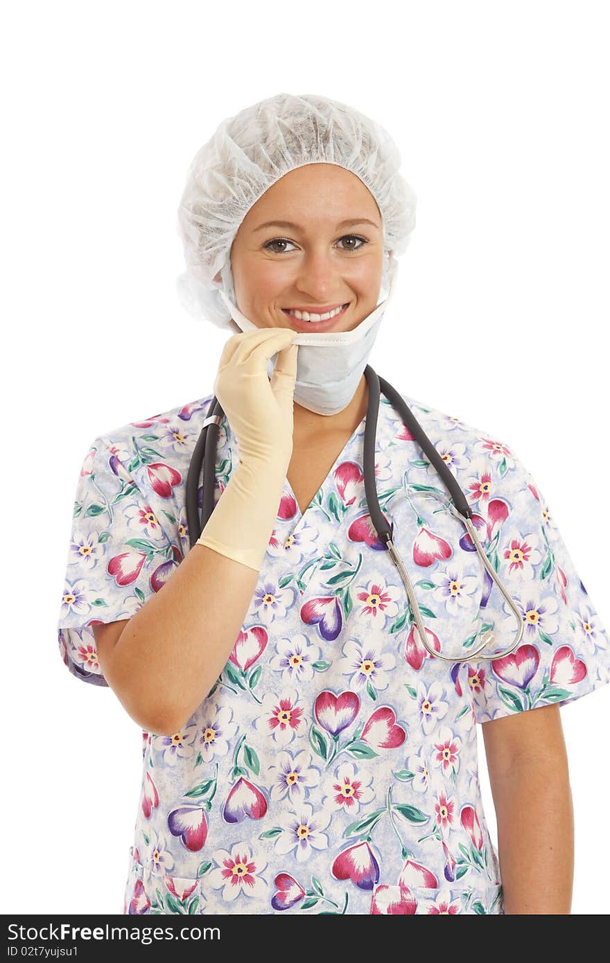 Portrait of young woman nurse in scrubs pulling on mask. Portrait of young woman nurse in scrubs pulling on mask