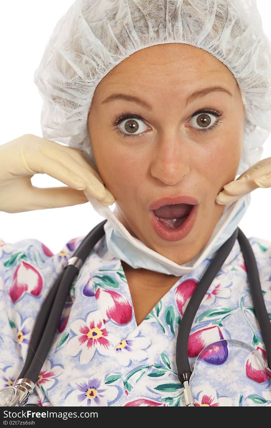 Humorous close-up portrait of young nurse with mask and cap