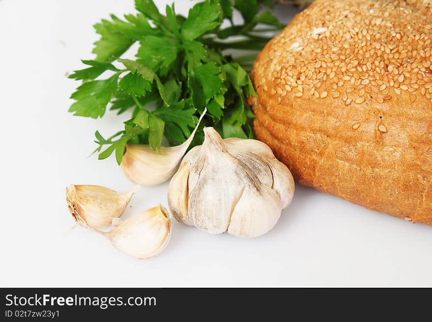 Bread with garlic and parsely on white background