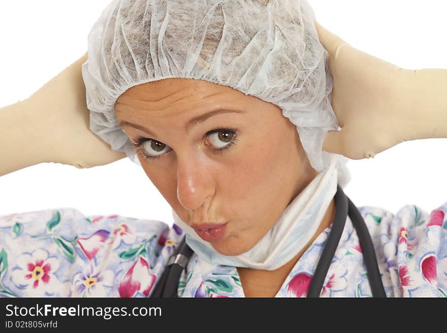 Humorous close-up portrait of young nurse with mask and cap