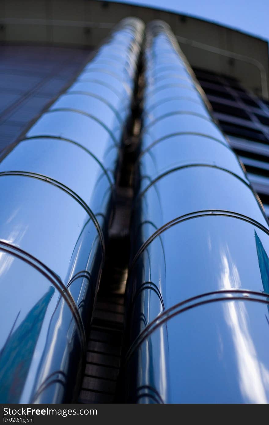 Vertical view of metal tubes on the exterior of a building. Vertical view of metal tubes on the exterior of a building.