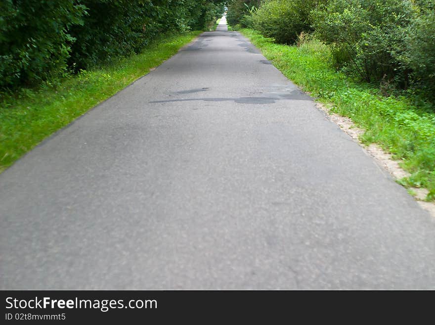 Motorway, asphalt road under fluffy clouds, fall scenic highway