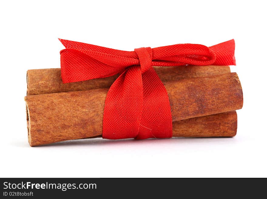 Cinnamon with red ribbon for Christmas isolated on white