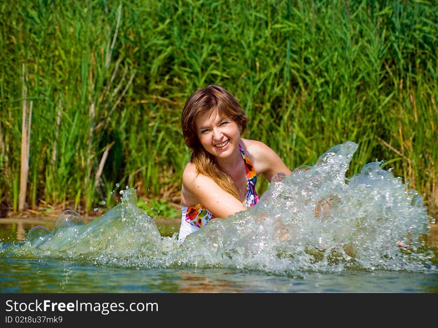 Beautiful girl playing in water. Beautiful girl playing in water