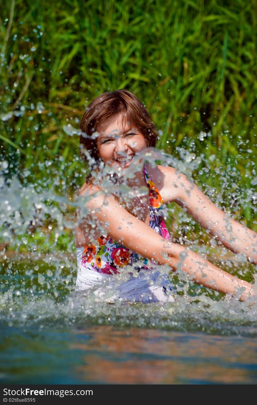 Beautiful girl playing in water. Beautiful girl playing in water