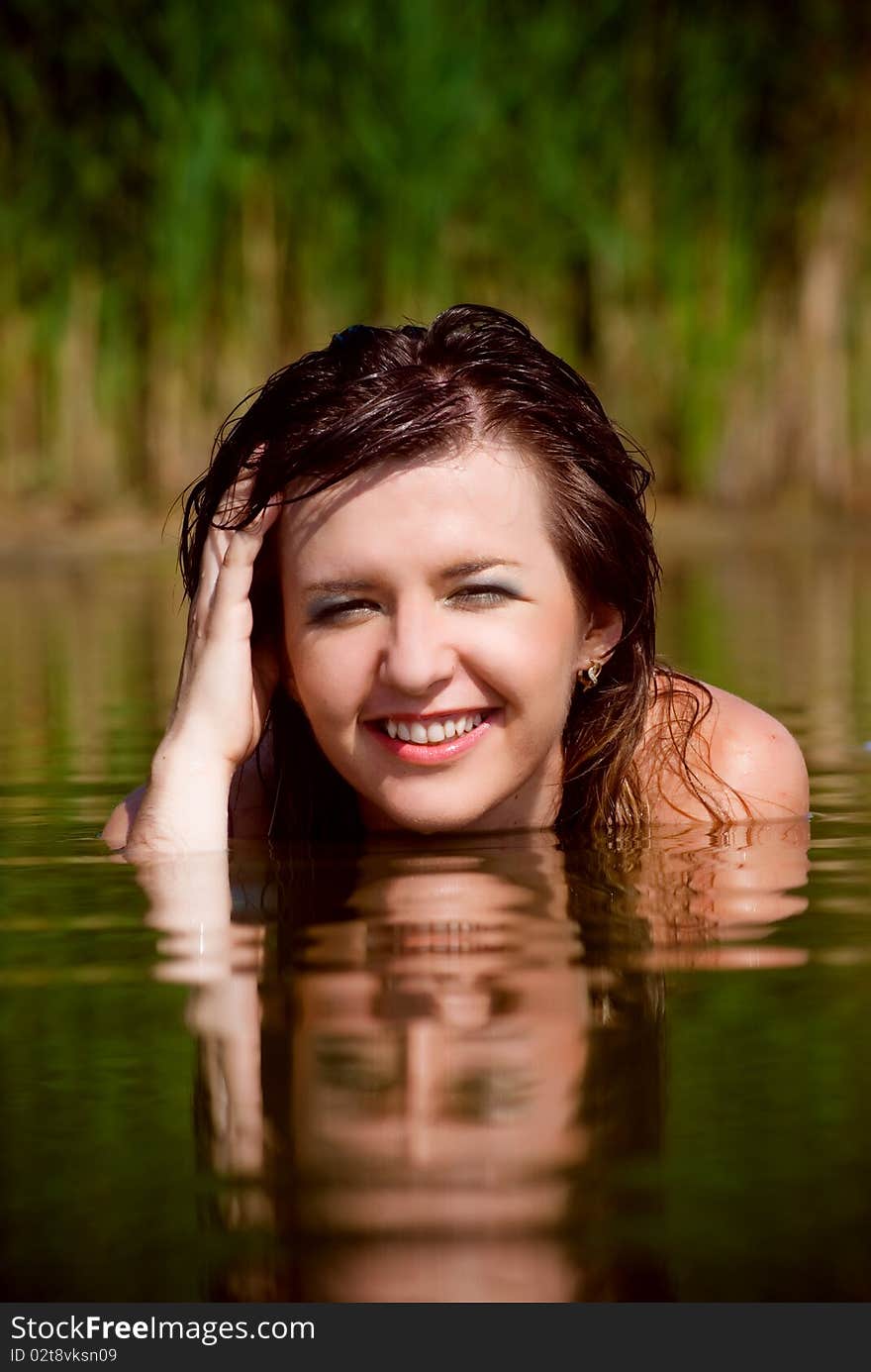 Beautiful girl in sarafan awash in water. Beautiful girl in sarafan awash in water