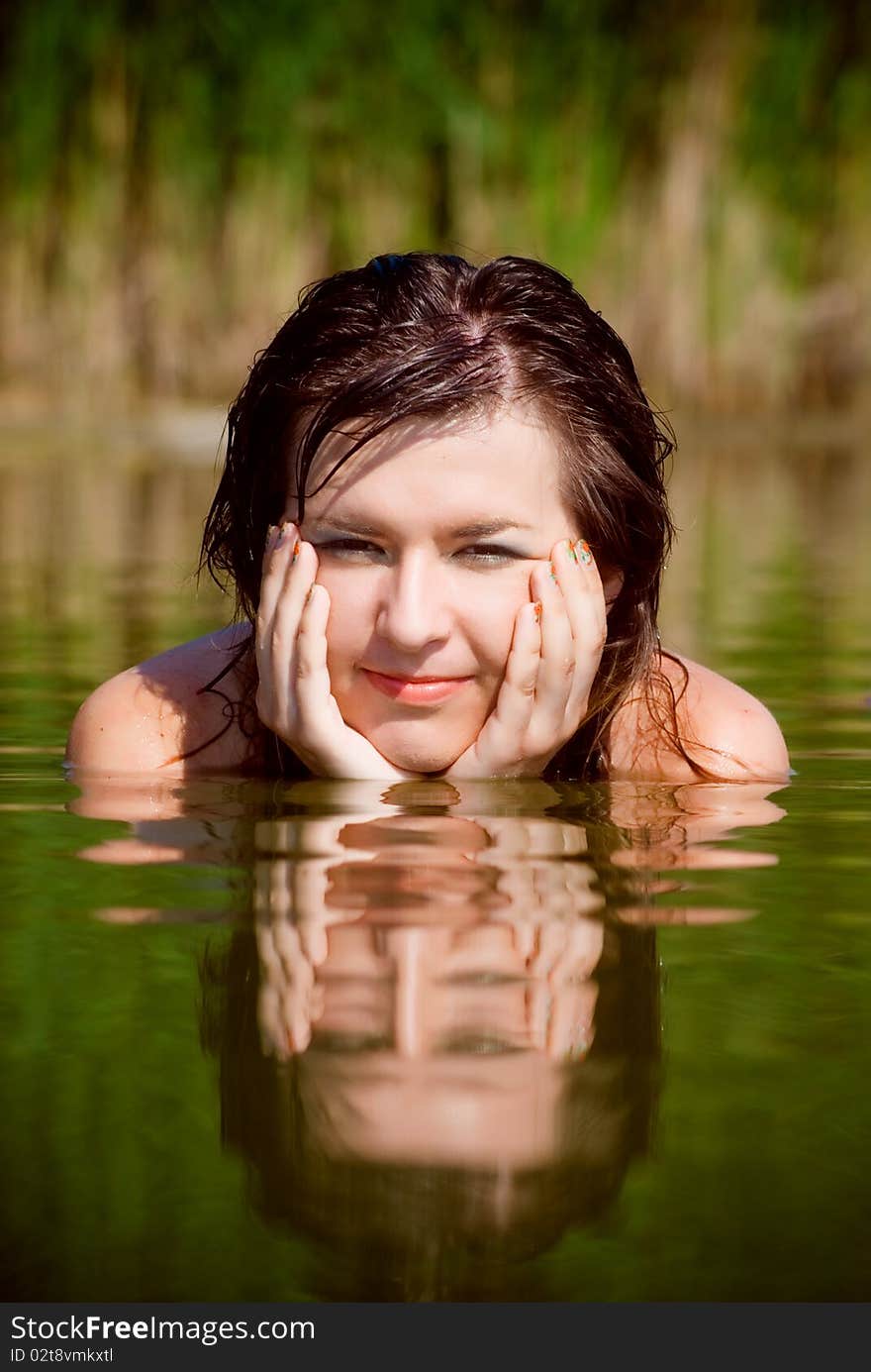 Beautiful girl in sarafan awash in water. Beautiful girl in sarafan awash in water