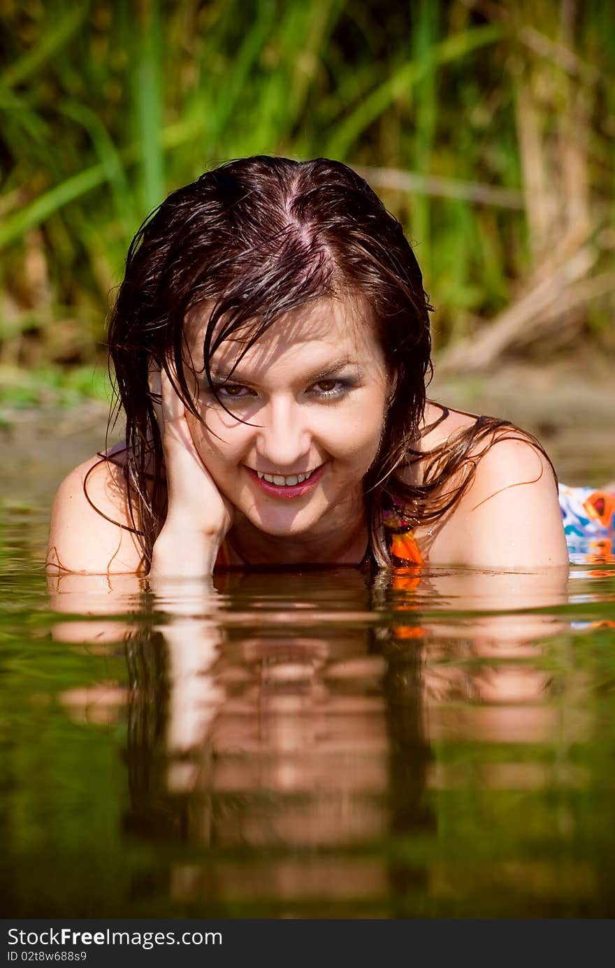 Beautiful girl in sarafan awash in water. Beautiful girl in sarafan awash in water