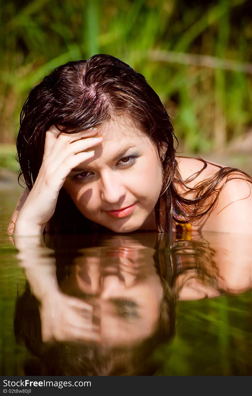 Beautiful girl in sarafan awash in water. Beautiful girl in sarafan awash in water