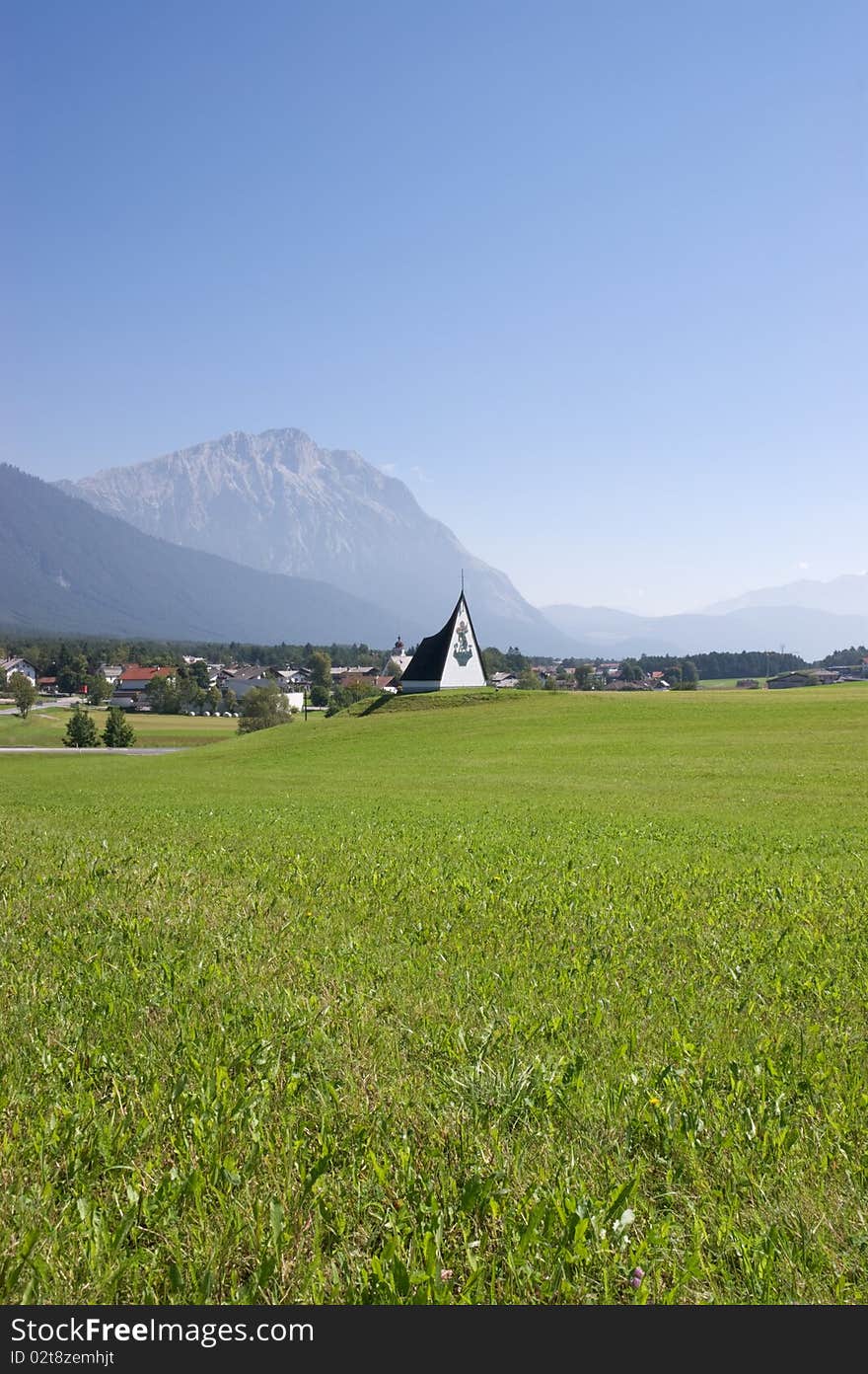 Summer alpine landscape in a misty morning