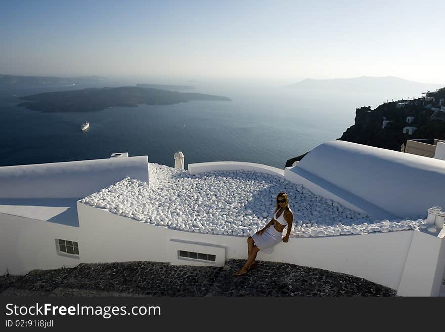 Young woman admires the sunset in Santorini, Greece. Young woman admires the sunset in Santorini, Greece