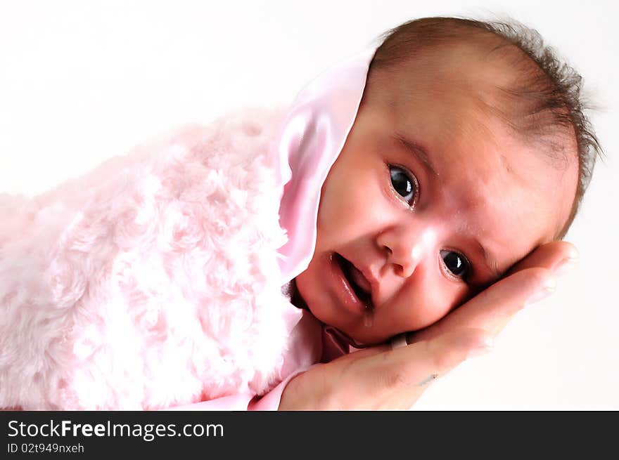 Baby girl wrapped in pink blanket held by father