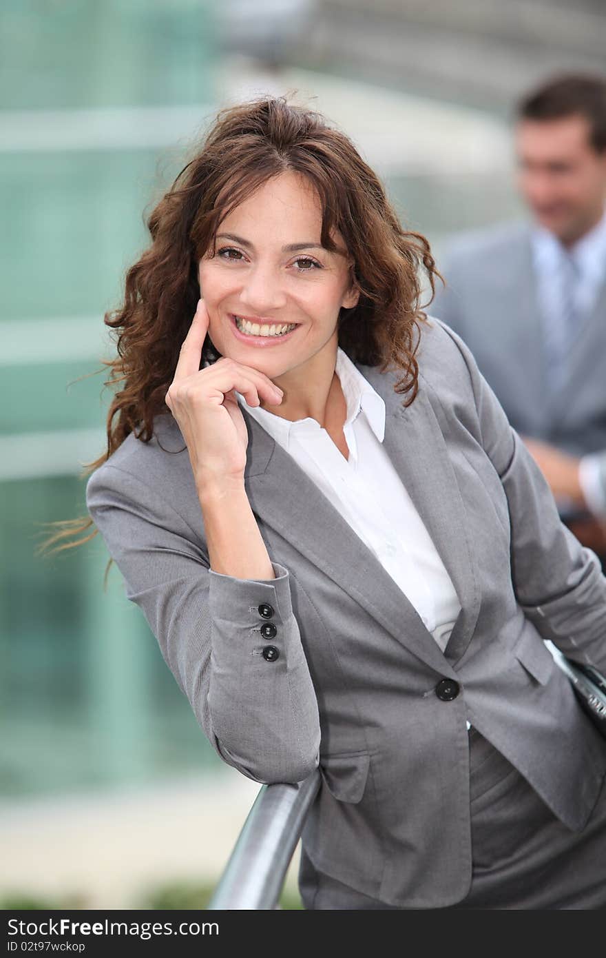 Portrait of businesswoman standing in front of businessemen. Portrait of businesswoman standing in front of businessemen