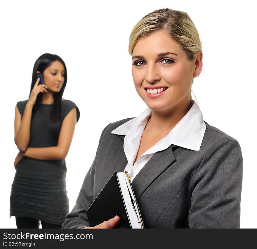 Confident young business woman with co-worker in background. Confident young business woman with co-worker in background