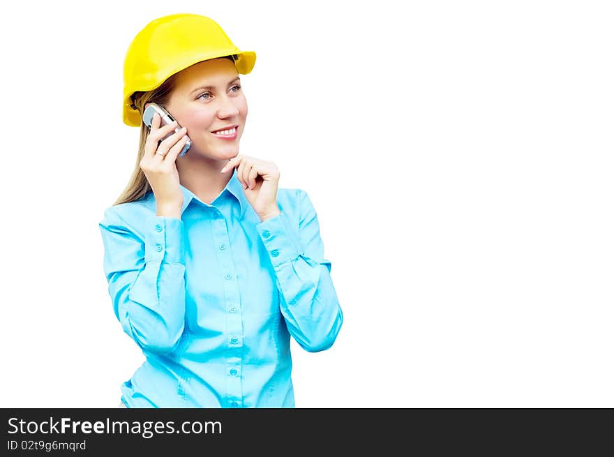 Young architect wearing a protective helmet standing on the building background