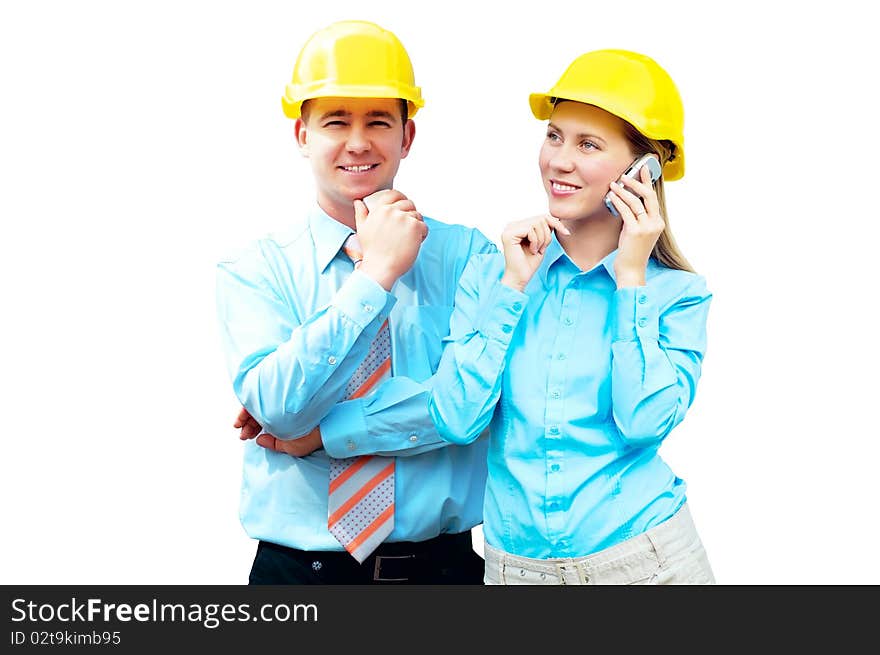 Young architects wearing a protective helmet standing on the building background