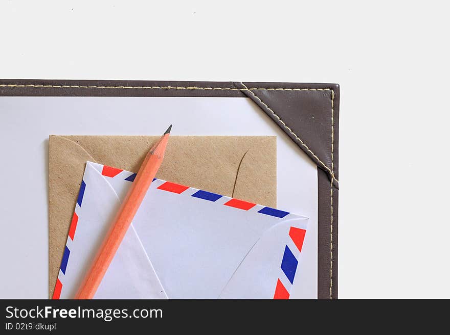 Letter paper, envelope and a wooden pencil isolated in white. Letter paper, envelope and a wooden pencil isolated in white.